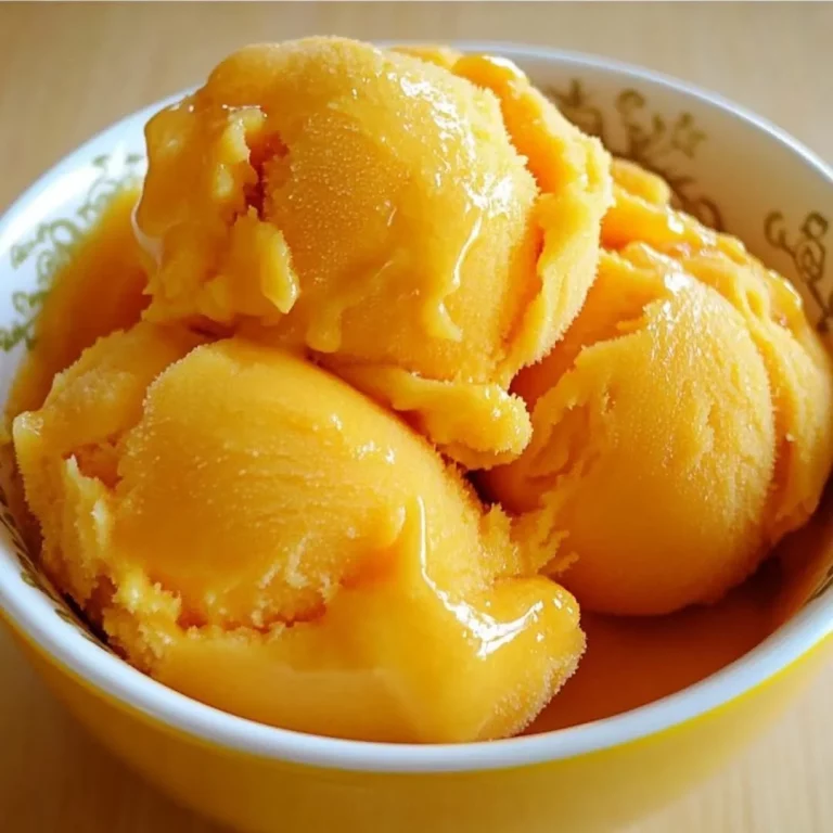 Delicious mango sorbet served in a scoop with fresh mango slices